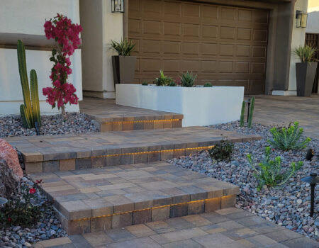 A home with a driveway and steps leading to the garage.