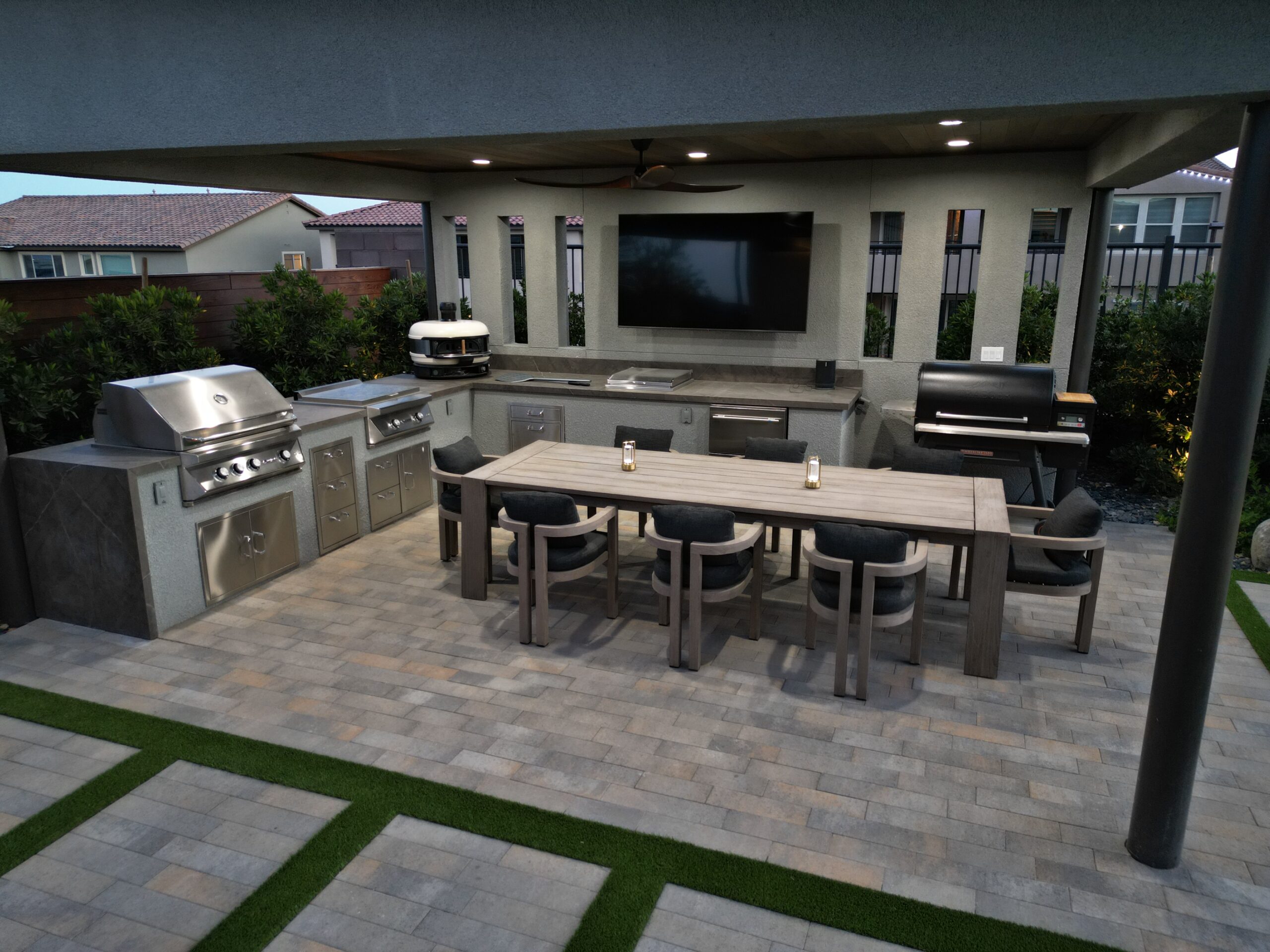 A large outdoor kitchen with an entertainment center. A large outdoor kitchen with an entertainment center.
