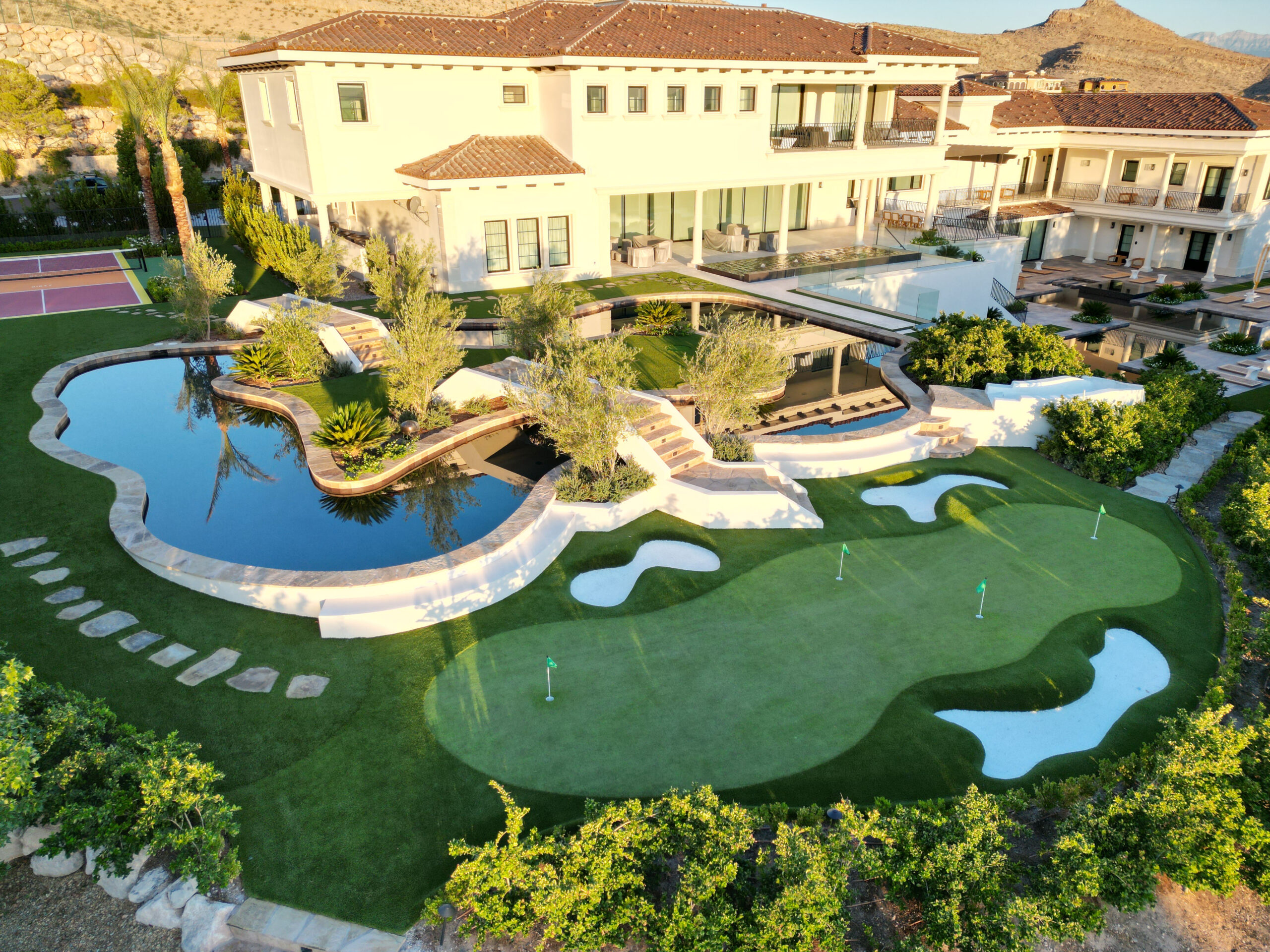A large pool with a golf course in the middle of it. A large pool with a golf course in the middle of it.