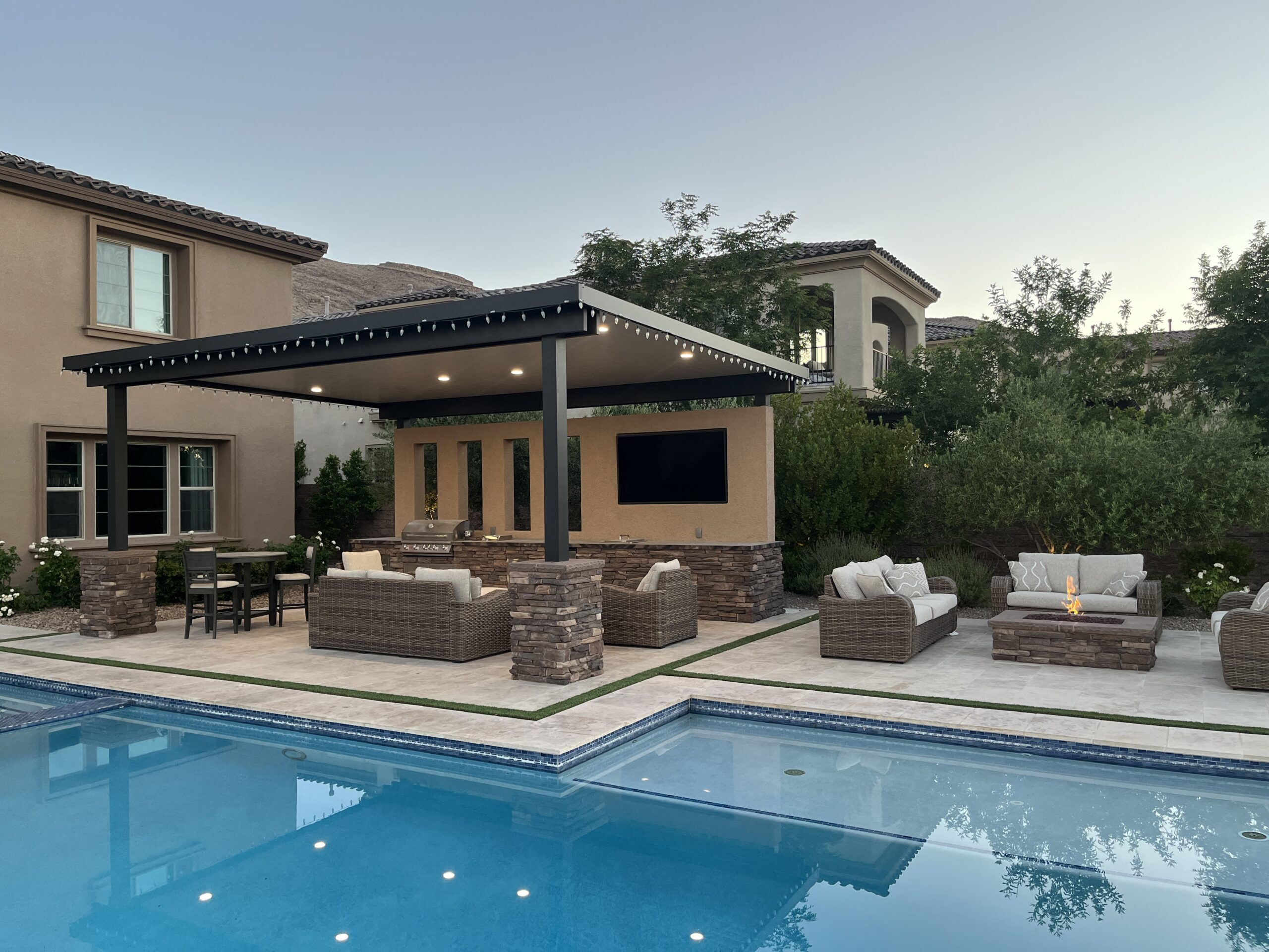 A pool with a covered patio and outdoor furniture. A pool with a covered patio and outdoor furniture.