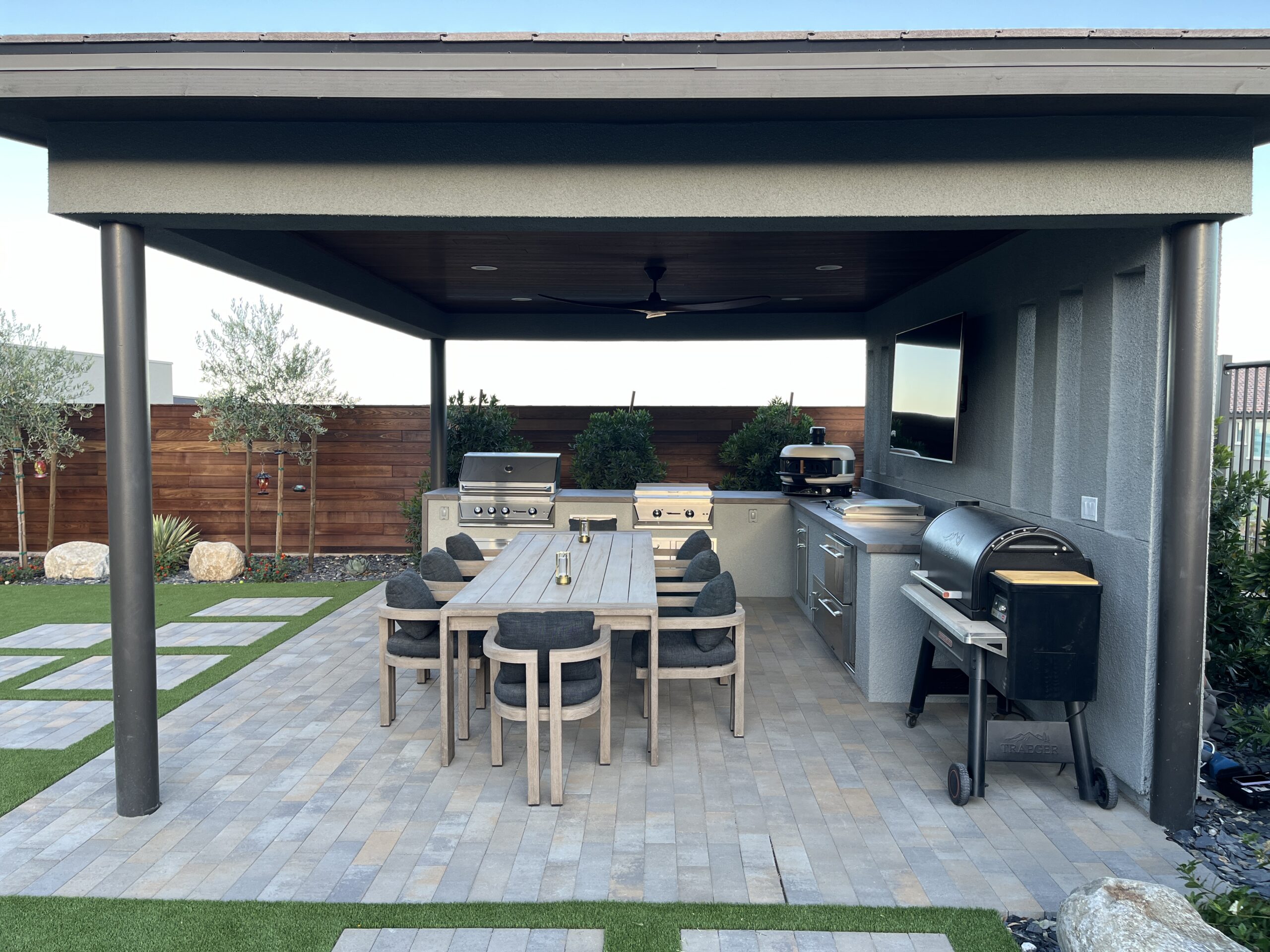 A patio with an outdoor grill and table