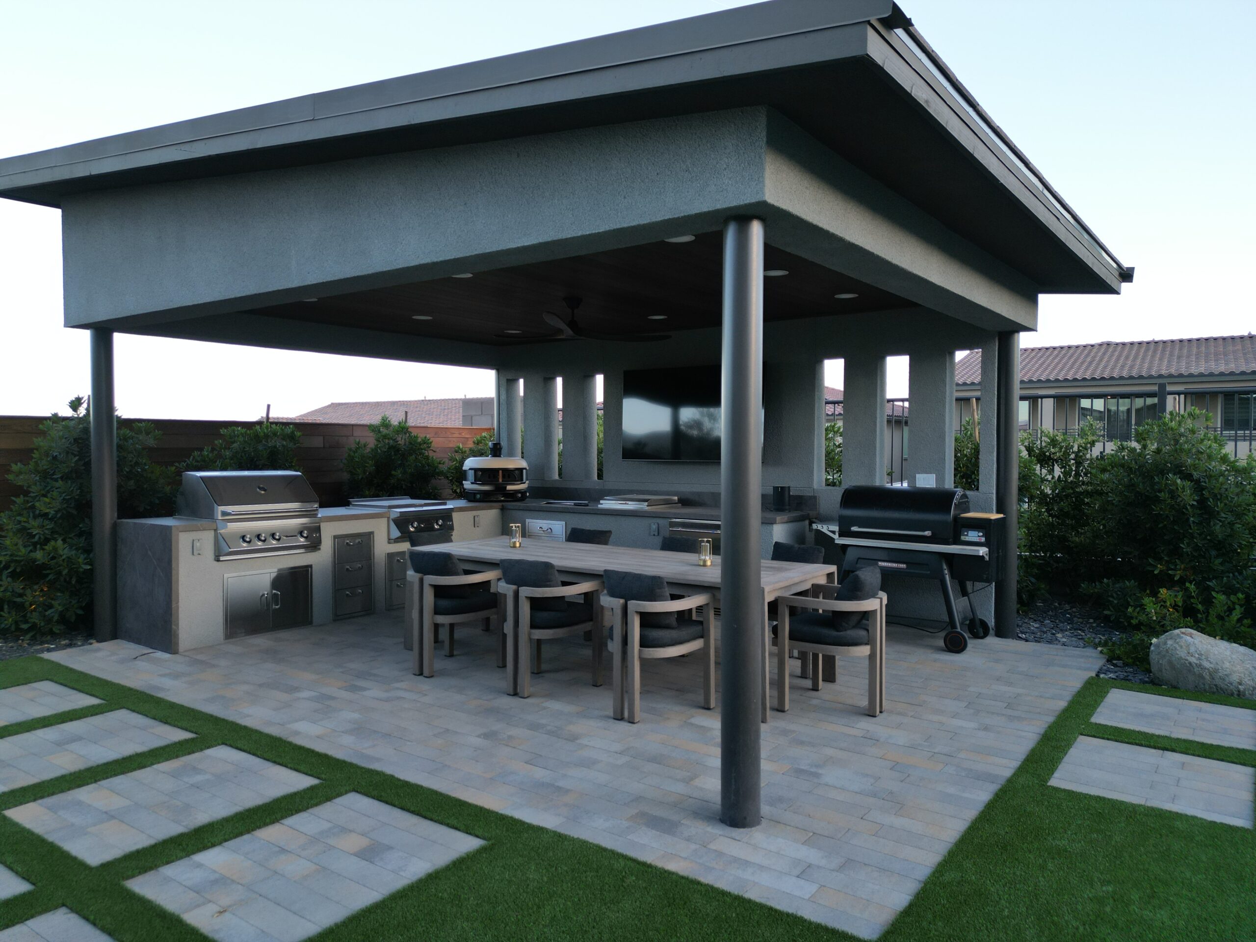 A patio with an outdoor grill and table
