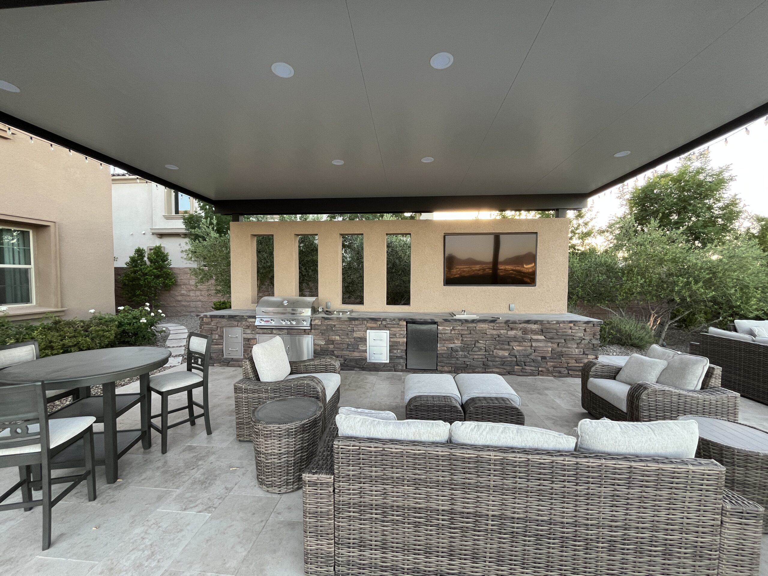 A patio with furniture and a television.